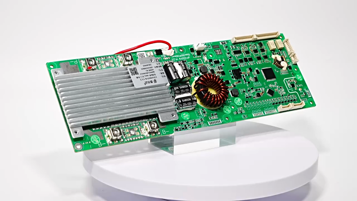JBD Smart BMS circuit board with aluminum heatsink and copper inductor coil, angled view