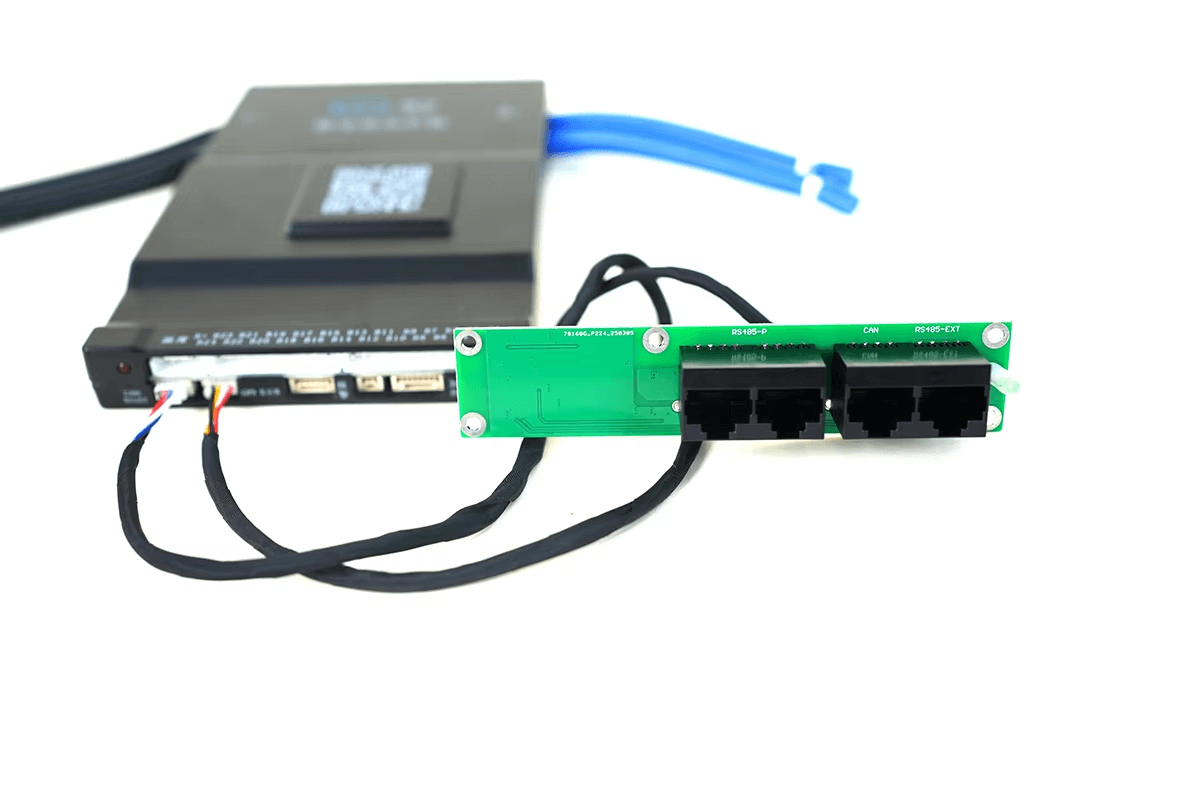Interface board connected to JKBMS unit with wiring harness, showing RJ45 ports and cable routing