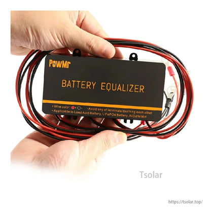 Hand holding battery equalizer with bundled red and black wires and ring terminals