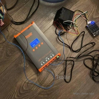 PowMr MPPT solar controller in use on floor with connected wiring and electronics test setup